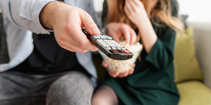 couple using a tv remote