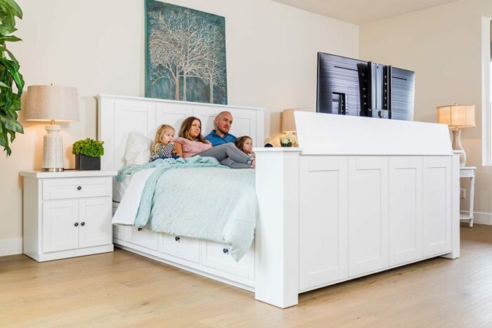 Family Watching TV in Bed Family laying in a TV Bed watching TV