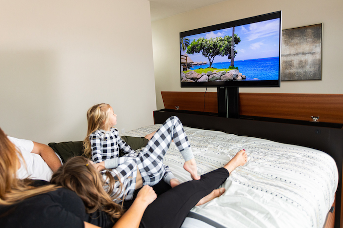 Family Watching TV in TV Bed