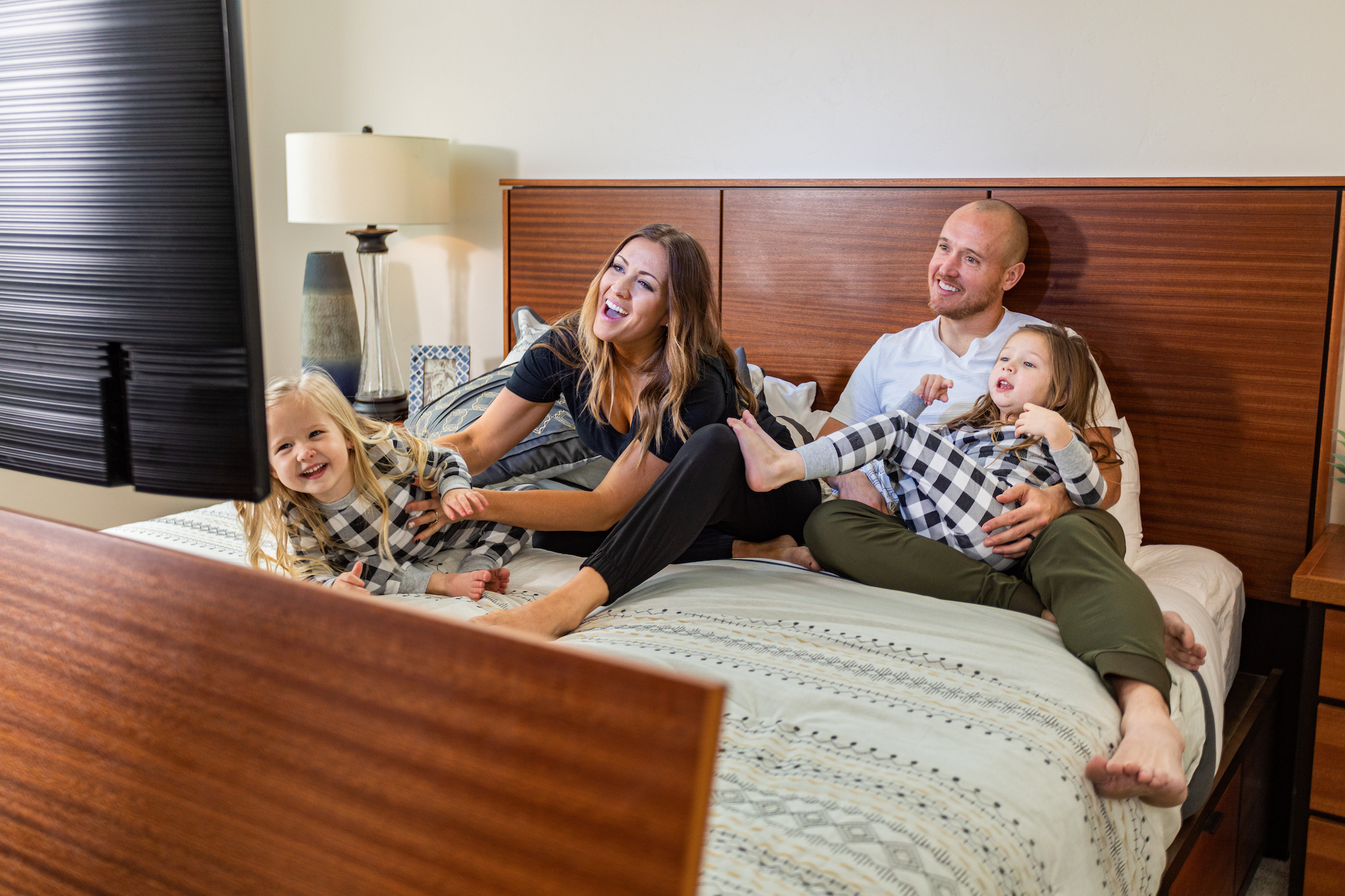 smiling family in TV bed