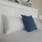 pillows against a white tv lift bed headboard