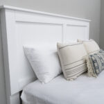 headboard of white tv lift bed with pillows leaning against it