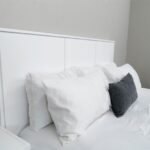 pillows against a white bed's headboard