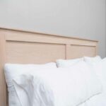 pillows against a wood bed headboard