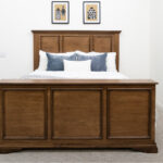 decorated dark wood bed